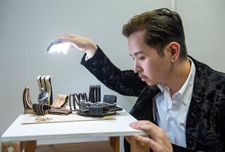 Product design student shining light on artwork