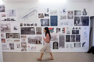 Student walking past architectural photos