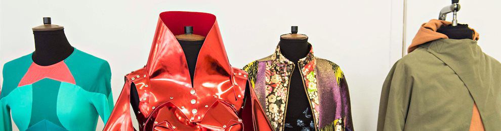 A collection of stylish jackets on display stands.