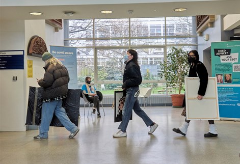 Students carrying artworks