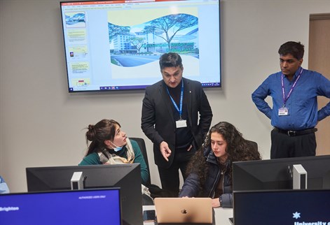 International Business Students talking to lecturer Hasan Gilani