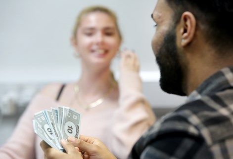 Student with monopoly money