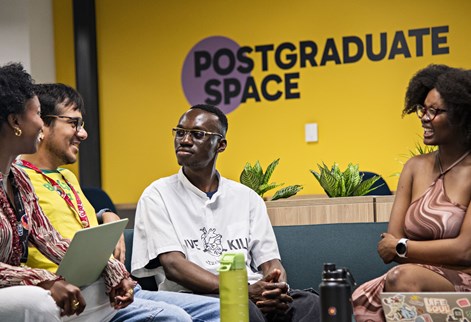 Students sitting together in a postgraduate study space