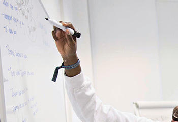 Marketing students working at a white board