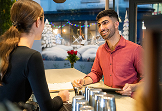 Placement student chatting to a coworker in a restaurant