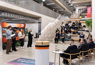 Students pitching to business owners in Elm House atrium