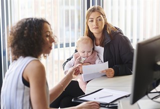 two women and a baby in an office