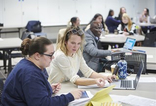 Law students sitting at desks with computers