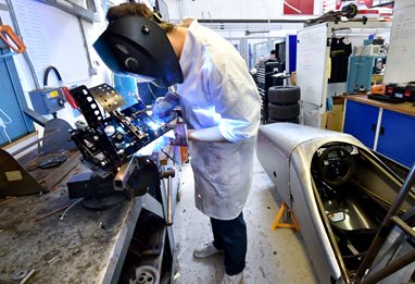 Student working on racing motor