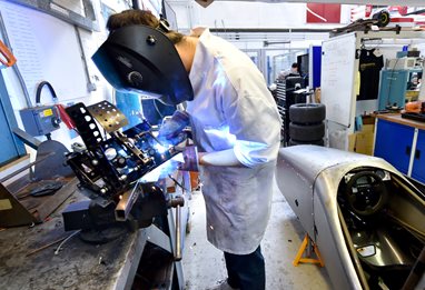 Student working on racing motor