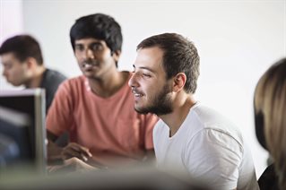 Two students looking at a computer screen