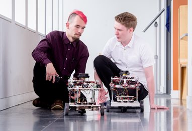 Computing students creating wheeled robots