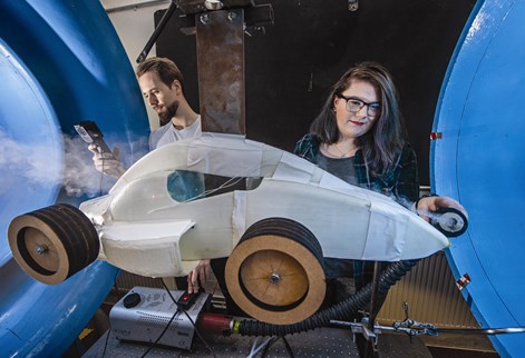 Students testing designs in the wind tunnel