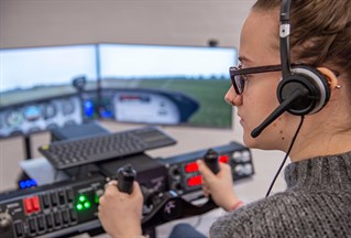 Female student close up on the flight simulator