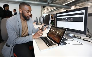 Male student working on app in front of computer