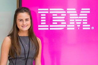 Female student standing in front of IBM sign