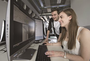 Two students in front of a computer screen