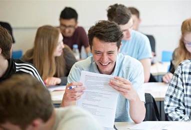 Student laughing at a written paper question