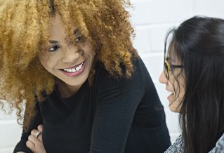 Two students in discussion during a seminar session