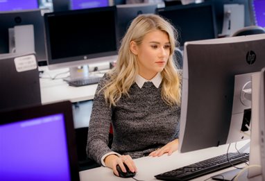 Student sitting alone in computer lab