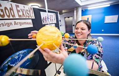 A student adjusting a 3D map of our solar system