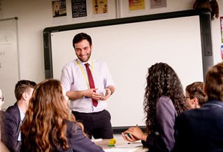 male trainee teacher in front of secondary class