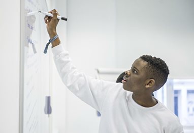 Student writing on a whiteboard