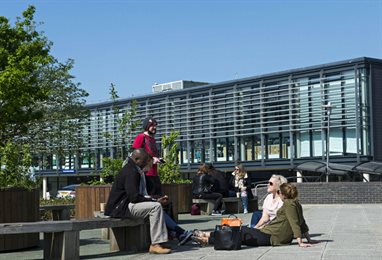 Students sitting on benches outside