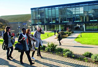 Students walking past Checkland building