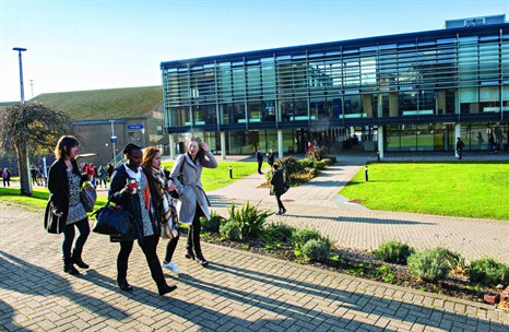 group of students walking through Falmer campus