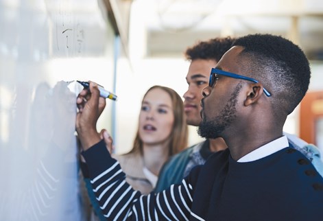 Students writing on a wipe board