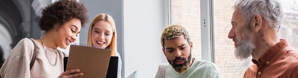 four people chatting in a corridor