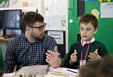 A child explaining something to his teacher