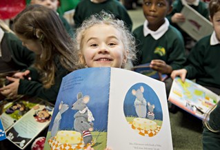 Child in a class with a book