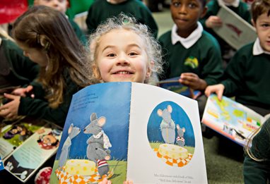 Smiling pupil with reading book