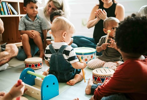 Babies playing with instruments at toddler group