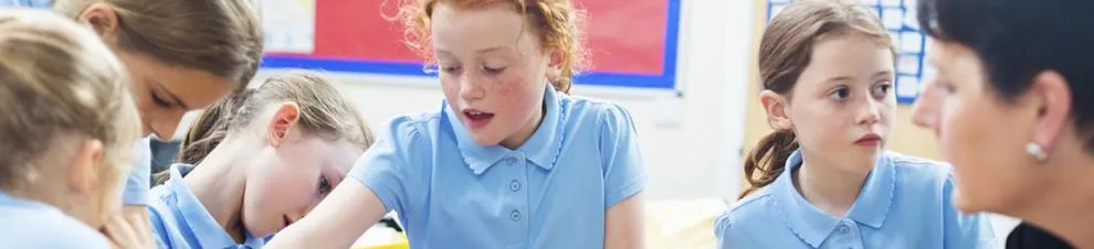 Group of children in blue uniform in classroom