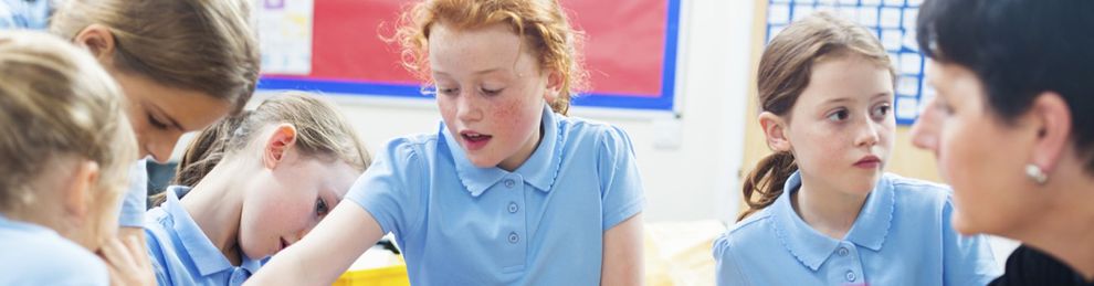 Group of children in blue uniform in classroom