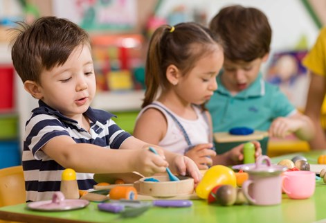 children playing with kitchen items