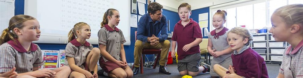 male teacher and children doing maths