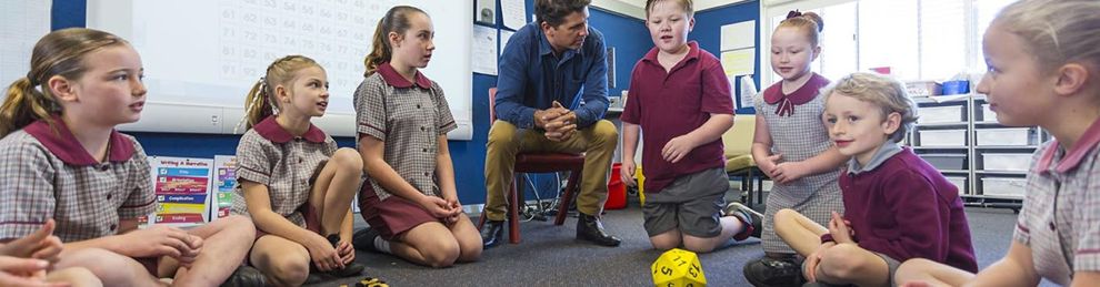 male teacher and children doing maths