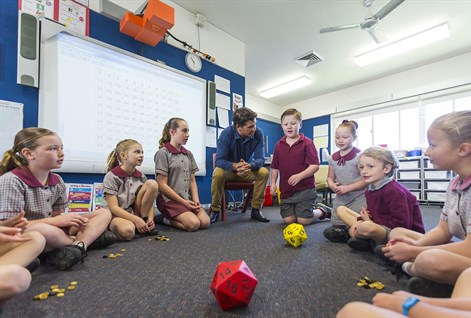 male teacher and children doing maths