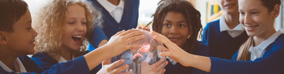 school children touching a plasma globe