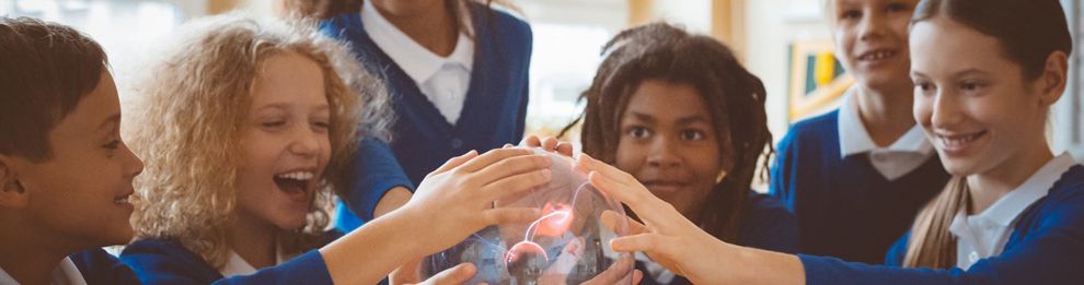 school children touching a plasma globe