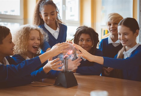 school children touching a plasma globe