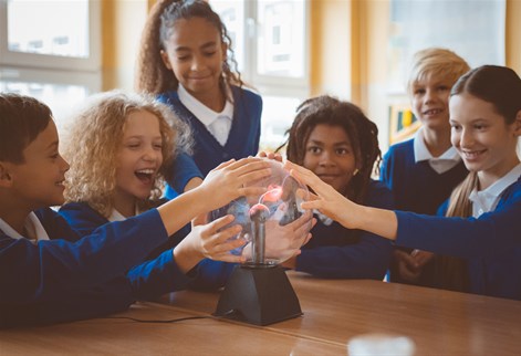 school children touching a plasma globe