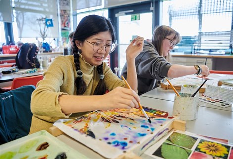 Art PGCE students painting over wax canvas