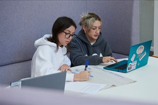 Childhood education students working from laptop