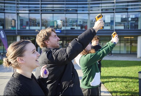 A group of geography trainee teachers using specialist equipment