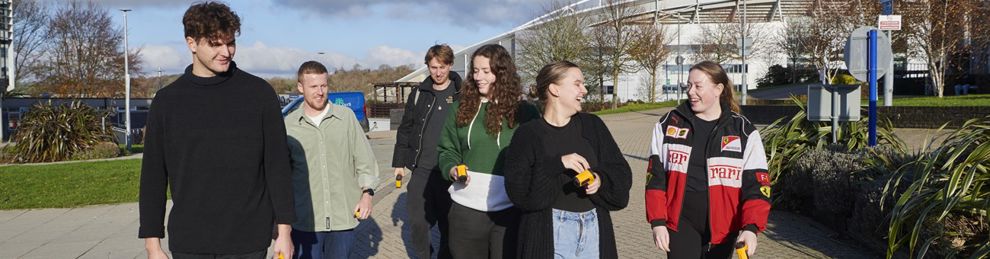 group of students walking through Falmer campus